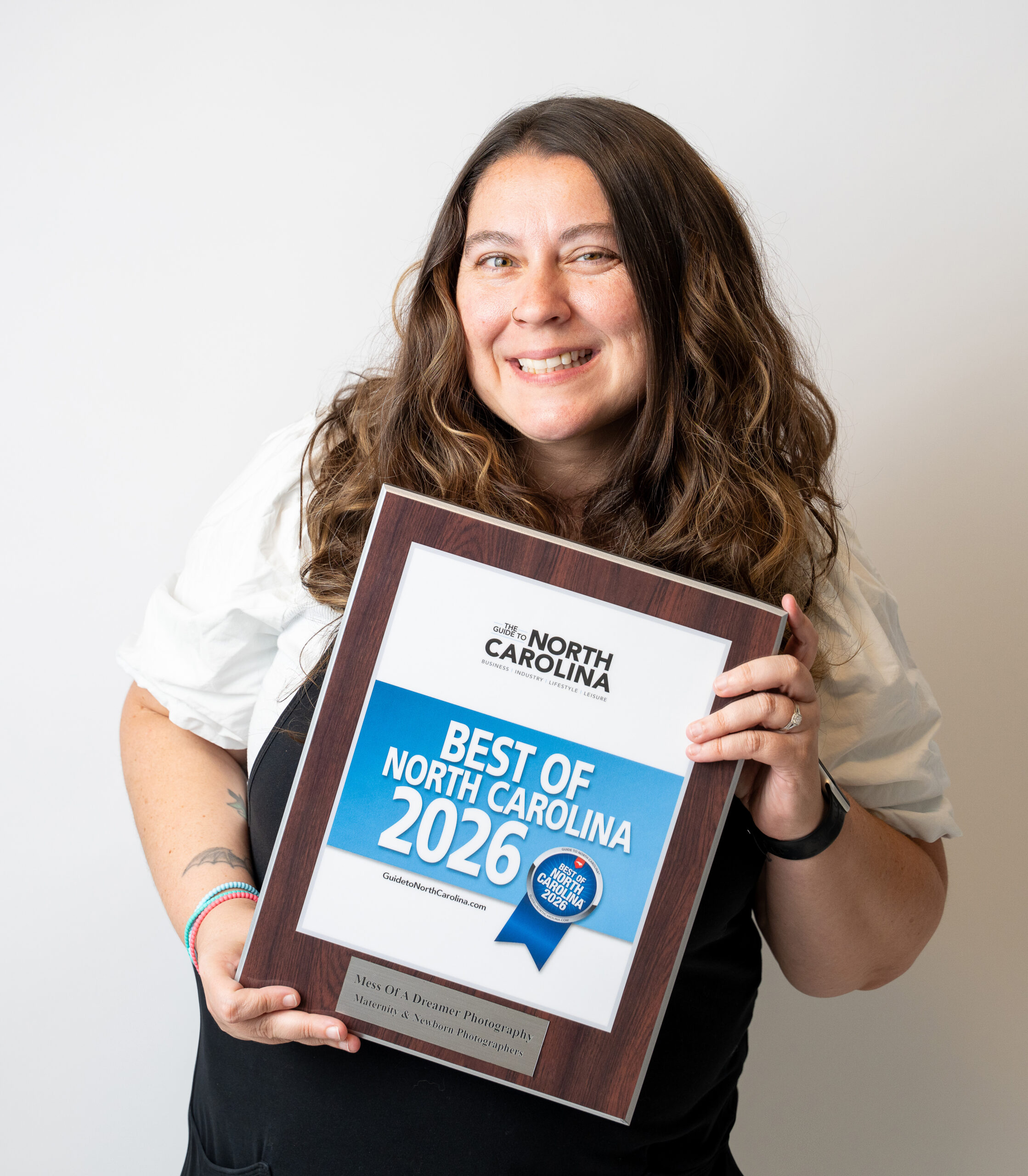 Bernice Isley, Raleigh Newborn Photographer holding her Best of NC 2026 award