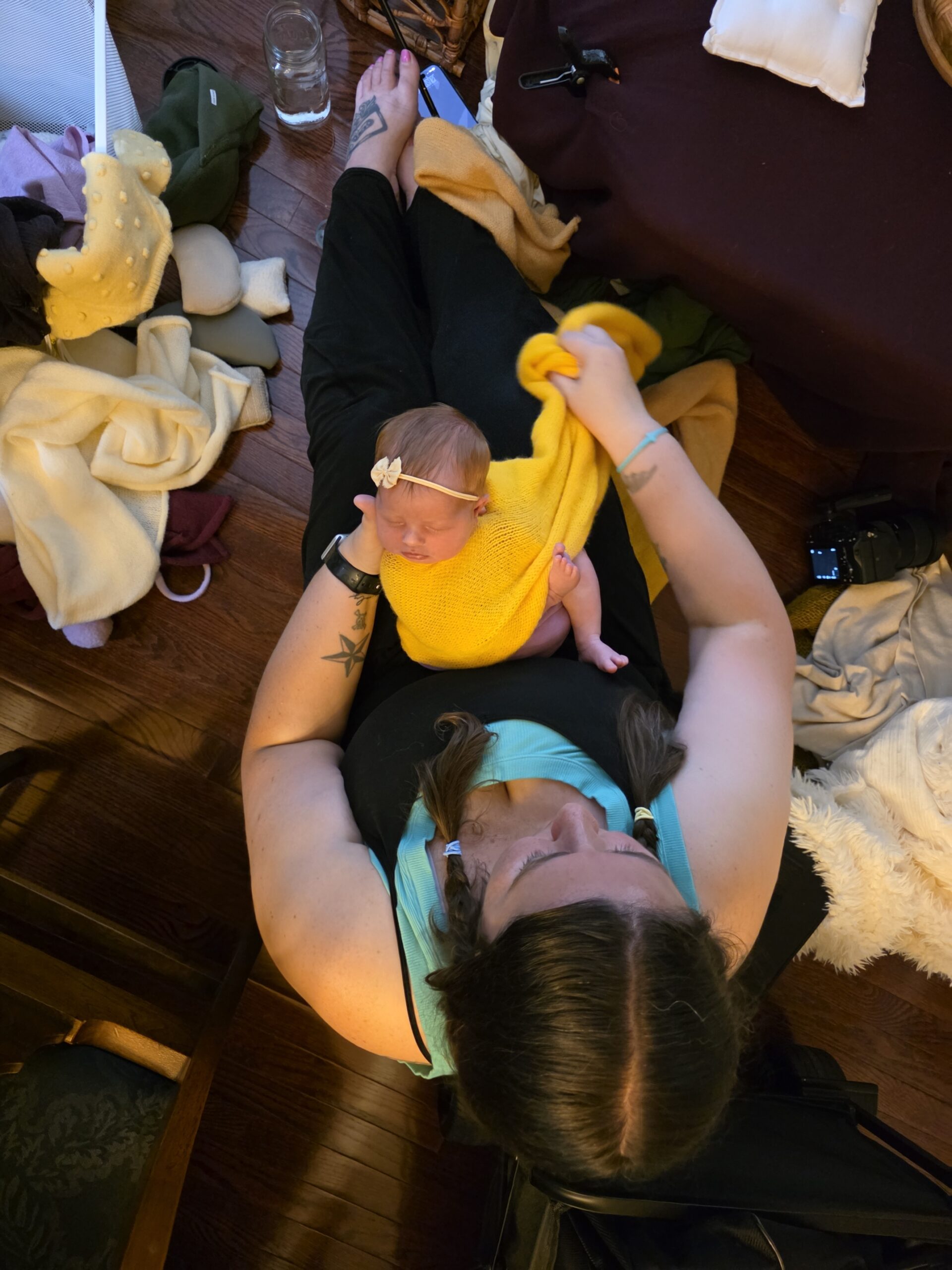 a raleigh newborn photographer wrapping a baby during an in-home newborn photography session